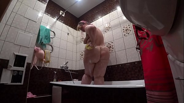 Peeking Through The Crack, A Secret Cam Catches A Thick-ass Slut Washing Off In The Bathroom.
